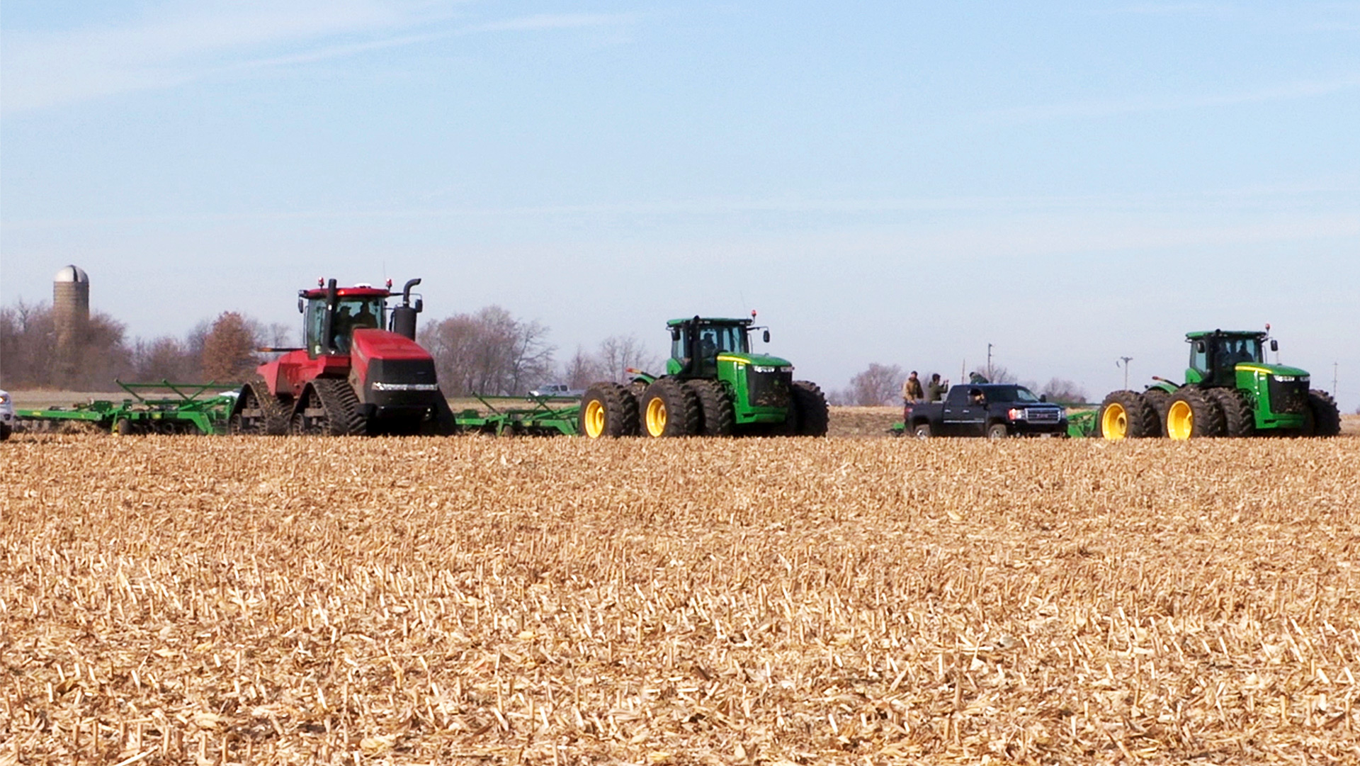 John Deere tractors in a field conducting a test to determine if tracks or tires perform better