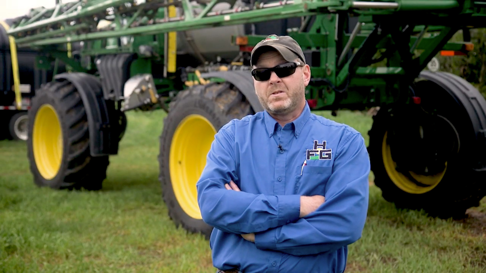 Mark Beason with Herbert Feed & Grains in front of John Deere tractor with LSW tires 